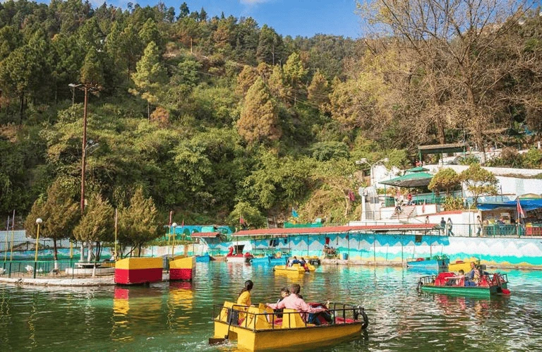 Top 12 Beautiful Hill Stations & Spiritual Destinations in Uttarakhand Mussoorie with a group of people in boats on Paraggi